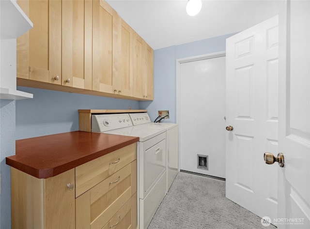 laundry area featuring cabinet space, light colored carpet, and washing machine and dryer