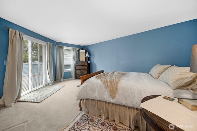 carpeted bedroom featuring access to outside