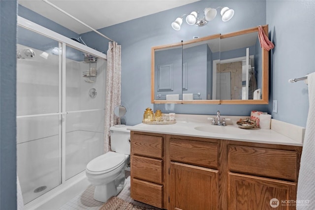 bathroom featuring tile patterned flooring, a shower stall, toilet, and vanity