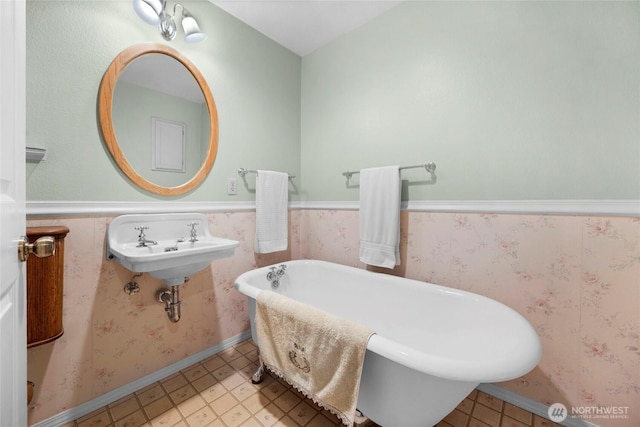 full bath with a freestanding bath and wainscoting