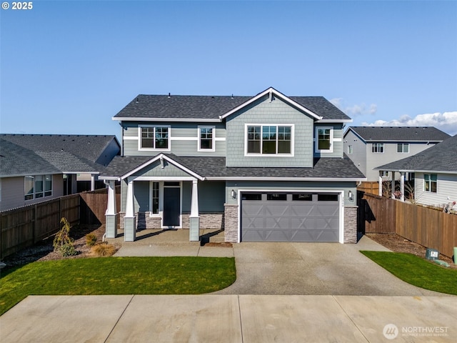 craftsman-style home with driveway, stone siding, fence, roof with shingles, and a garage