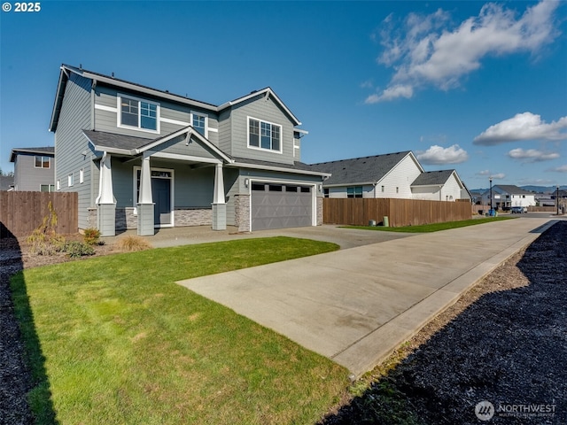 craftsman inspired home with stone siding, concrete driveway, a garage, and fence