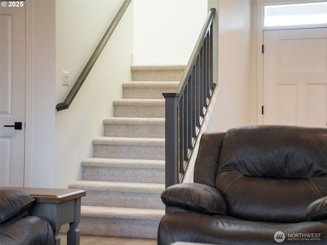 stairway with wood finished floors