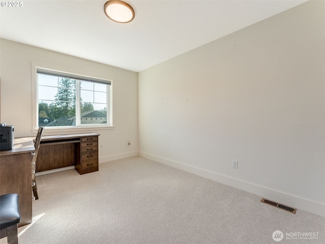 office area featuring baseboards, visible vents, and light carpet