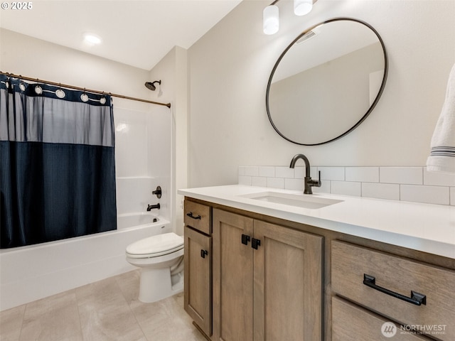 bathroom featuring shower / bathtub combination with curtain, toilet, vanity, and tile patterned flooring