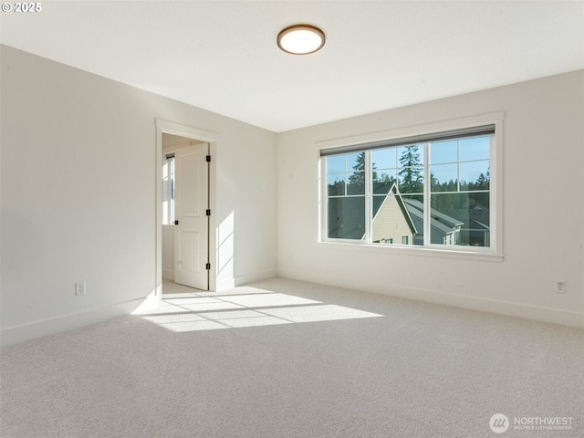 empty room with baseboards and carpet floors