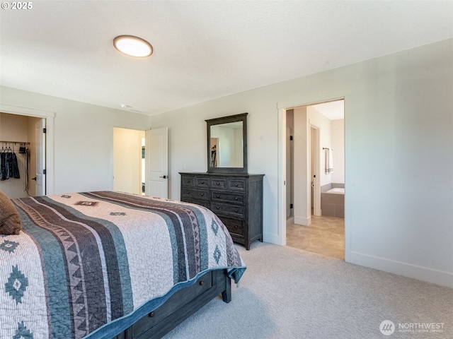 bedroom featuring light carpet, ensuite bathroom, and baseboards