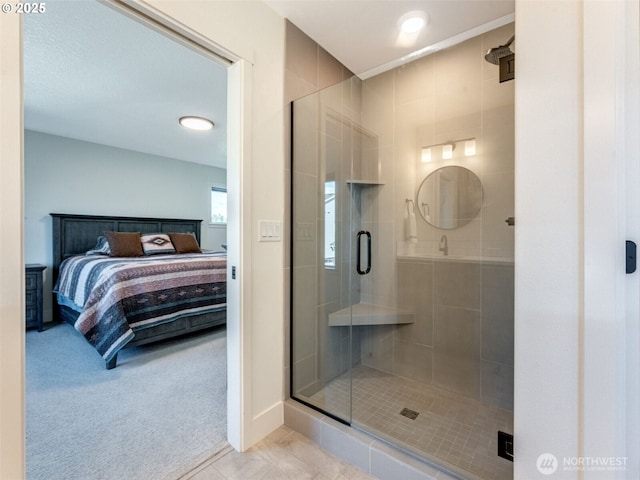 ensuite bathroom with tile patterned floors, connected bathroom, and a shower stall