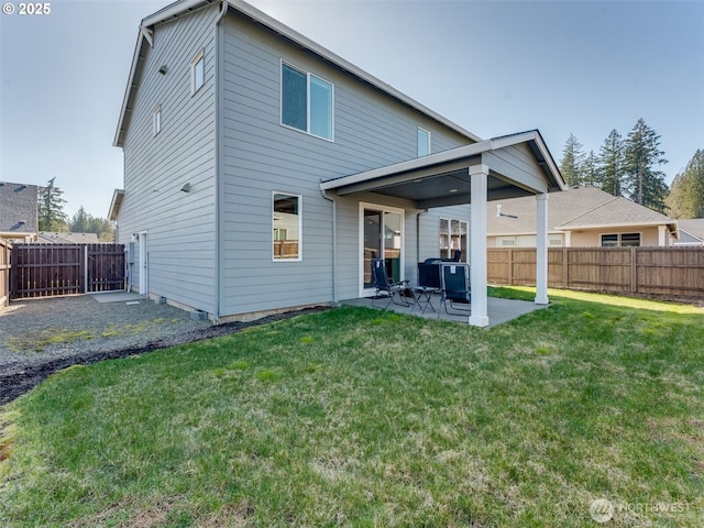 rear view of property featuring a patio, a fenced backyard, and a lawn