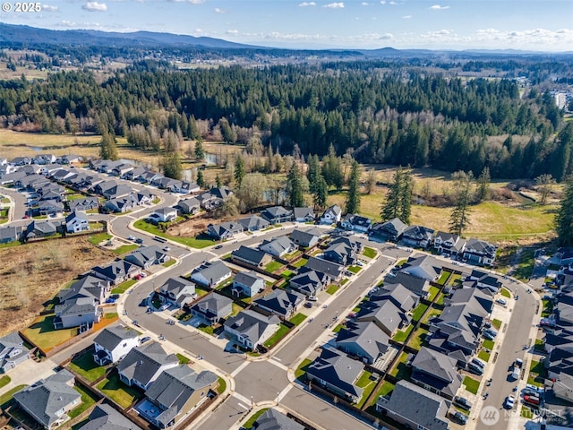 bird's eye view with a residential view and a wooded view