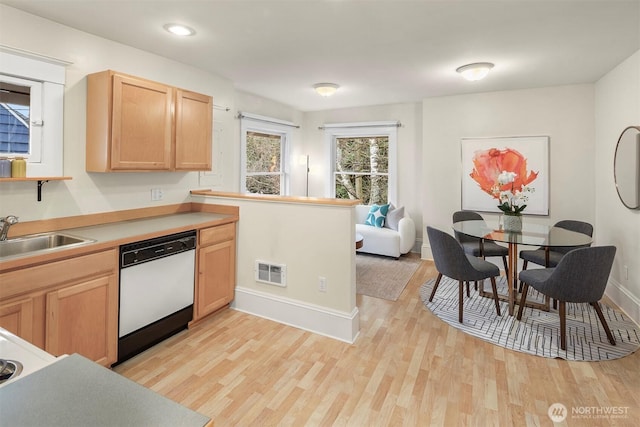 kitchen with visible vents, light brown cabinetry, a sink, white dishwasher, and light wood finished floors