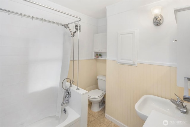 bathroom featuring a sink, toilet, tile patterned floors, and shower / tub combination