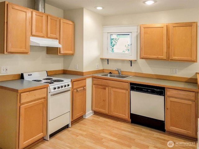 kitchen with white appliances, light brown cabinets, light wood-style flooring, a sink, and under cabinet range hood