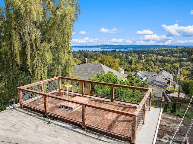 wooden deck featuring a view of trees and a water view