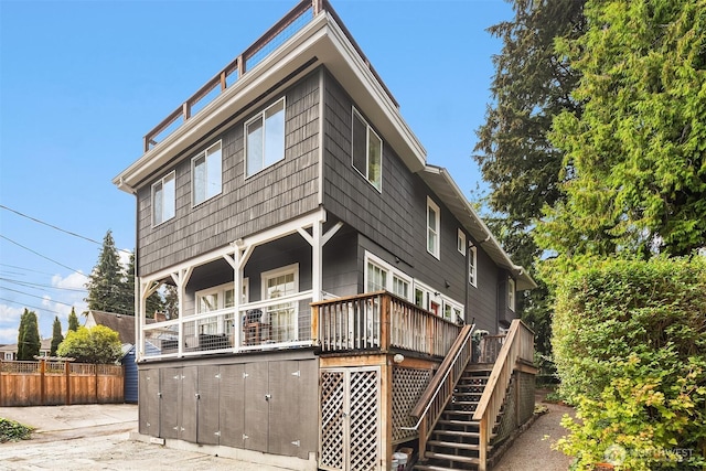 view of front of house featuring stairs and fence