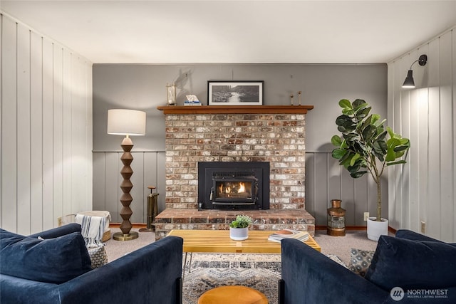 carpeted living area with a fireplace