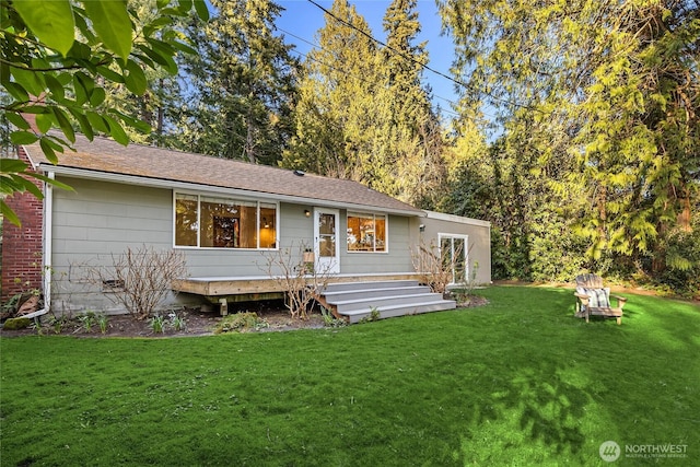 rear view of house with a yard