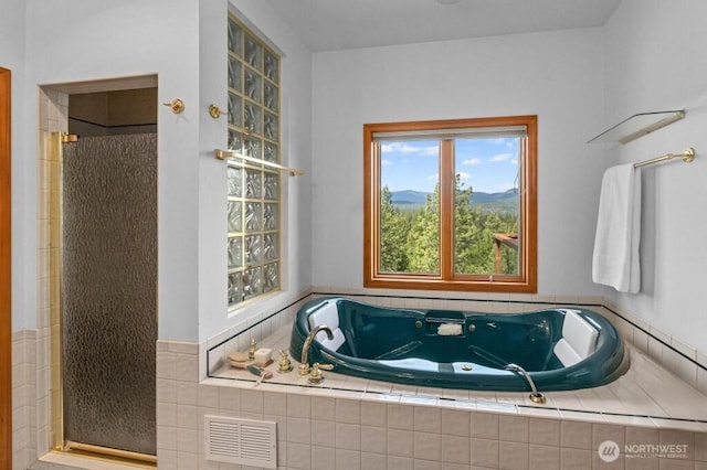 full bath with visible vents, a whirlpool tub, and a walk in shower