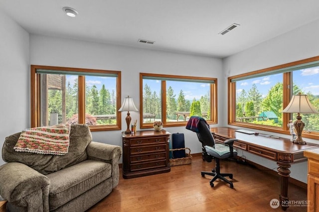 office area with visible vents and wood finished floors