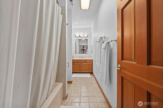 bathroom with visible vents, shower / bath combo with shower curtain, tile patterned flooring, baseboards, and vanity