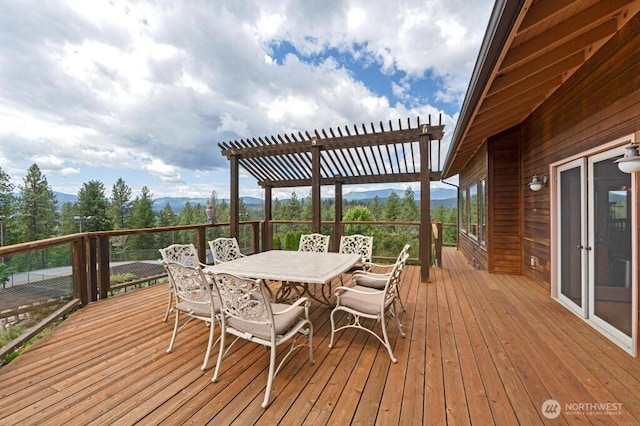 deck featuring outdoor dining space and a pergola