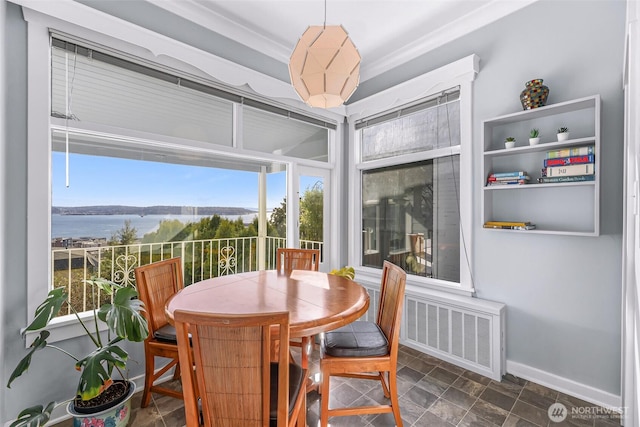 307 W Highland Dr, Seattle, WA 98119 - dining area featuring radiator heating unit, baseboards, and a water view