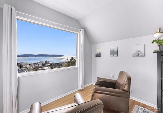307 W Highland Dr, Seattle, WA 98119 - sitting room with vaulted ceiling, wood finished floors, baseboards, and a water view