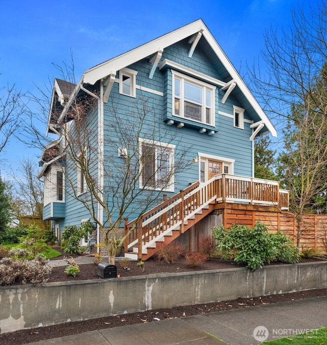 view of front of home with stairs and a deck