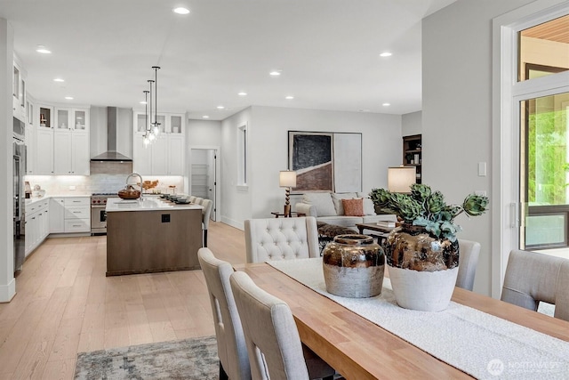 dining area featuring light wood-style flooring and recessed lighting