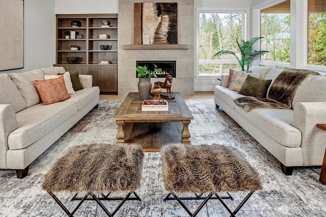 living room featuring a tile fireplace