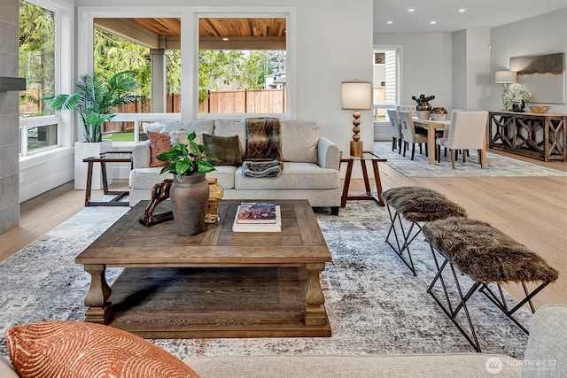 living area with a wealth of natural light, recessed lighting, and wood finished floors