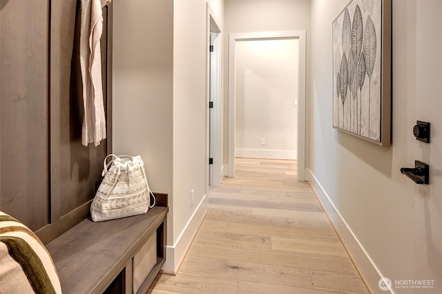 hallway with baseboards and light wood-style flooring