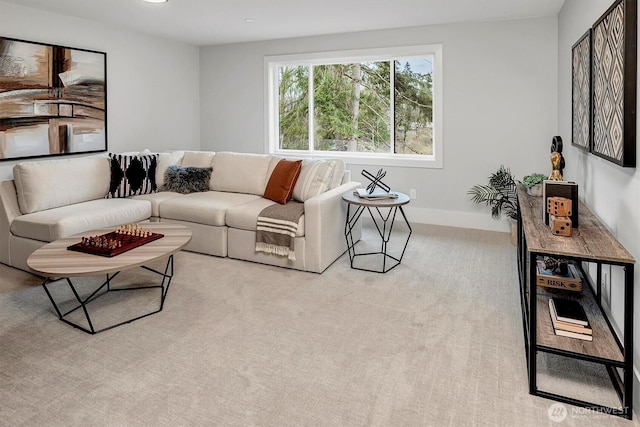 carpeted living area featuring baseboards