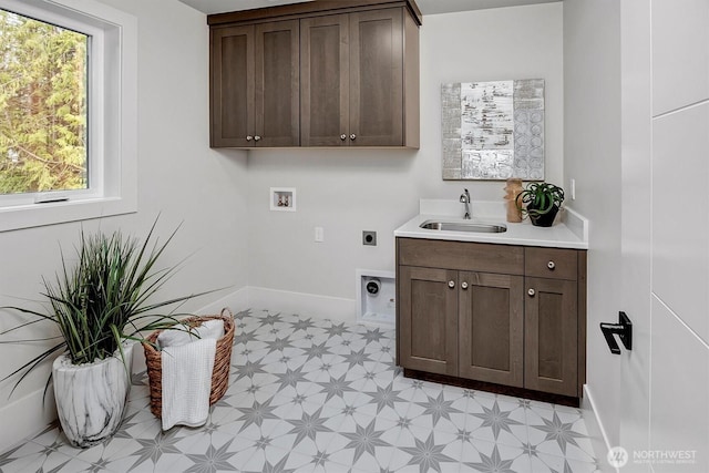 washroom featuring light floors, baseboards, electric dryer hookup, washer hookup, and a sink