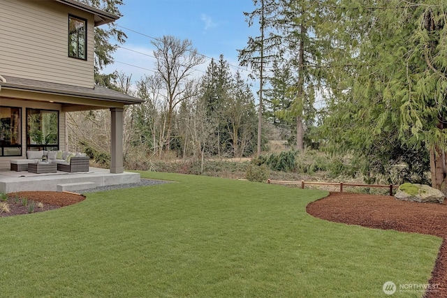 view of yard with an outdoor living space and a patio