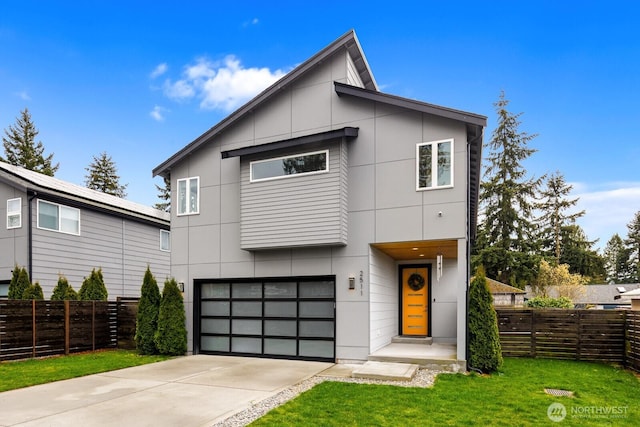 modern home featuring driveway, a front yard, a garage, and fence