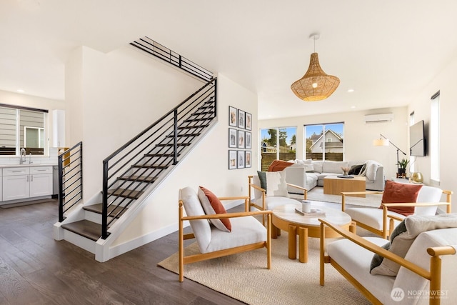 interior space featuring stairway, recessed lighting, a wall unit AC, and dark wood-style flooring