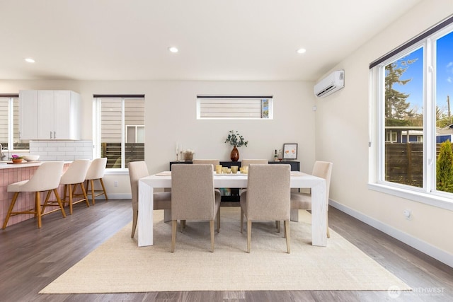 dining area with a wall unit AC, recessed lighting, baseboards, and light wood finished floors