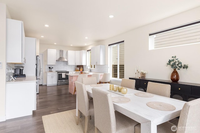 dining area with recessed lighting and dark wood-type flooring