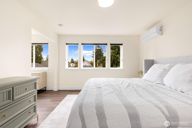 bedroom featuring dark wood-type flooring, radiator heating unit, baseboards, and a wall mounted AC