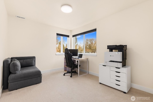 office space with visible vents, light colored carpet, and baseboards