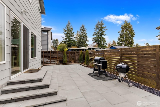 view of patio featuring a grill and a fenced backyard