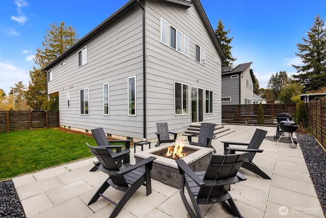 back of property with a patio area, a lawn, a fire pit, and a fenced backyard