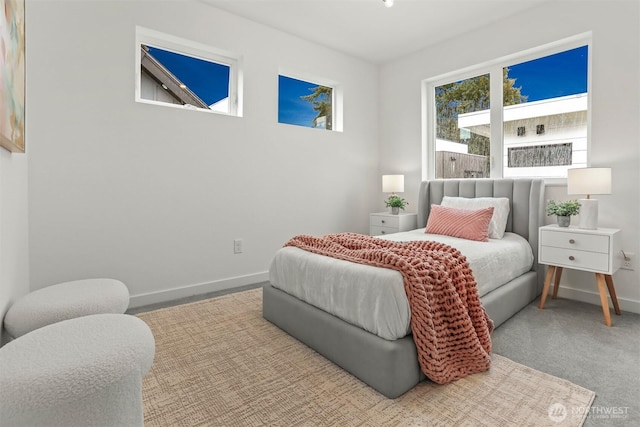 carpeted bedroom featuring baseboards