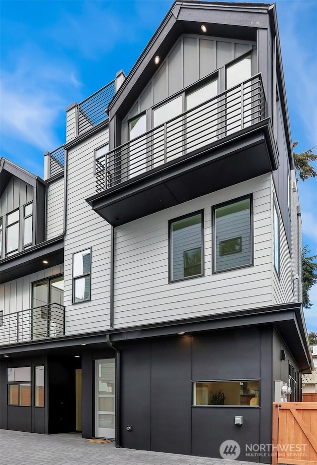 exterior space with a balcony and fence