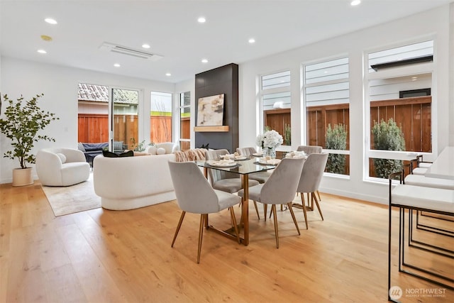 dining area featuring light wood finished floors, recessed lighting, and baseboards