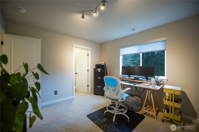 office area featuring visible vents, baseboards, track lighting, and carpet flooring