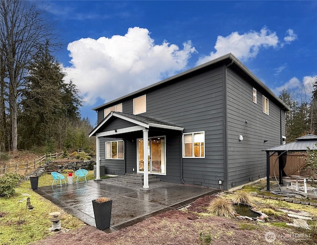 rear view of property featuring a gazebo, crawl space, and a patio