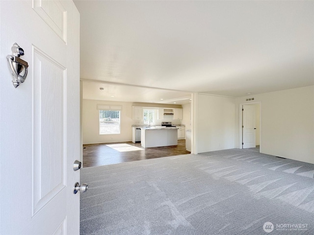 unfurnished living room with carpet