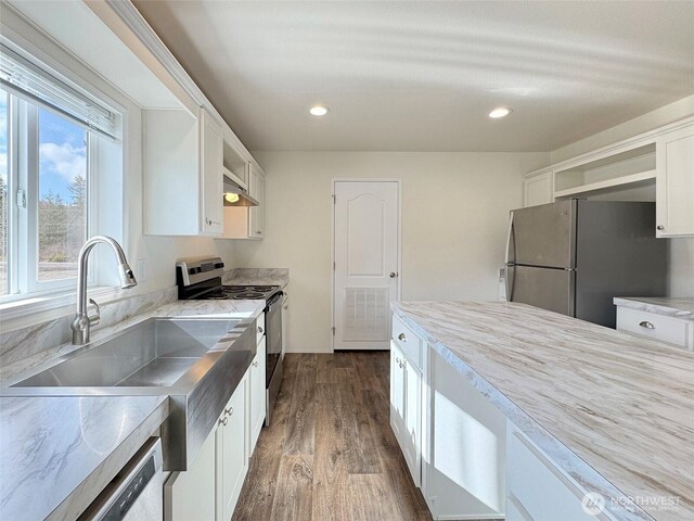 kitchen featuring dark wood-style floors, open shelves, a sink, stainless steel appliances, and white cabinets